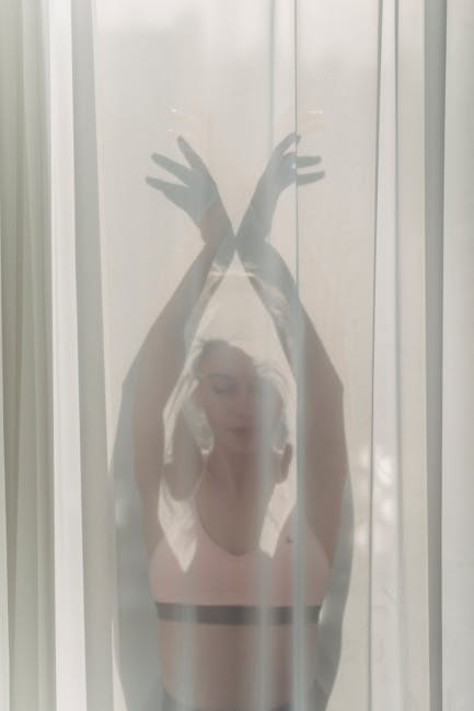 Woman performing a gentle yoga pose in a bright, peaceful living room setting.